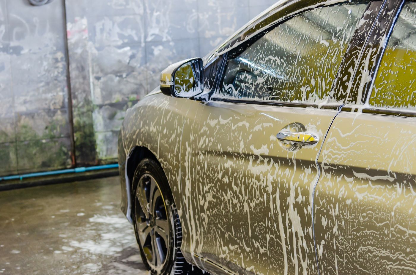 Car covered in foam during an exterior hand wash